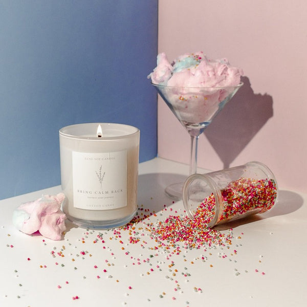 Experience the nostalgic aroma of Cotton Candy with our scented candle. Enjoy the sweet scent of strawberry, peach, caramel, vanilla, sugar cane, and musk that transports you back to the local fair. Presented in a reusable glass jar with sealable lid and drawstring bag, the 270g of 100% natural soy wax will burn for 40+ hours, perfect for any decor.